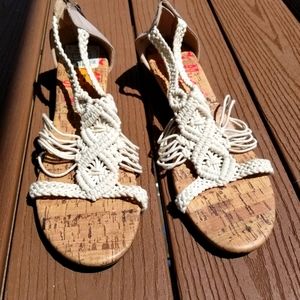 Size 11 Sandal with a white nylon design and cork sole.